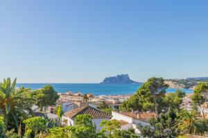 a view of a town with the ocean in the background at Casa Once Moraira in Teulada