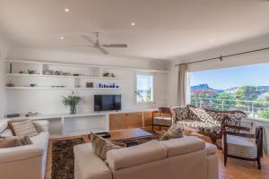 a living room with white furniture and a large window at Casa Once Moraira in Teulada