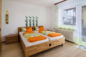 a bedroom with two beds and a window at Ferienwohnung Kramer in Überlingen