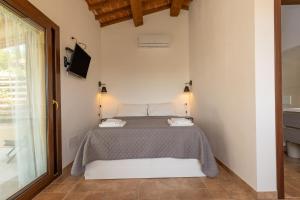 a bedroom with a bed and a large window at Oltremare in Riparbella +65 photos
