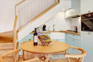a kitchen with a table with a bottle of wine at Casa do Calhau in Câmara de Lobos