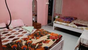 a room with two beds in a room at Melody residency in Cherrapunji