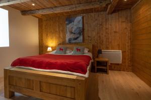 a bedroom with a bed in a room with wooden walls at Ferme de Faustine 2 - piscine in Saint-Gervais-les-Bains +20 photos