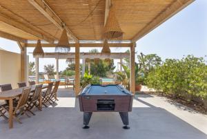 a pool table on a patio with a table and chairs at Can Juan Pedro in La Mola