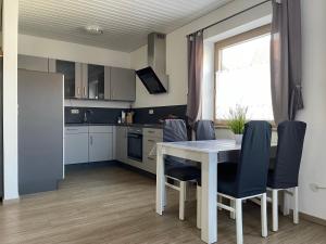 a kitchen and dining room with a table and chairs at Ferienwohnung M Keller in Hollfeld