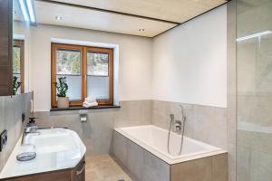 a bathroom with a bath tub and a sink at Apartment Luisa in Scharnitz +25 photos