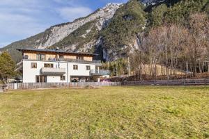 a large white house in front of a mountain at Apartment Luisa in Scharnitz