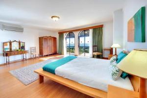 a bedroom with a large bed and a large window at Villa Albuar in Patroves +24 photos