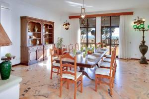 a dining room with a wooden table and chairs at Villa Albuar in Patroves