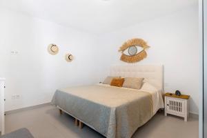 a bedroom with a bed and a mirror on the wall at El Pasero in El Golfo