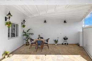 a dining room with a table and chairs at El Pasero in El Golfo +17 photos
