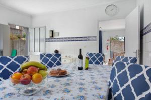 a table with a bowl of fruit on top of it at Casa da Ribeira da Janela in Porto Moniz