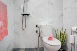 a white bathroom with a toilet and a shower at Casa da Ribeira da Janela in Porto Moniz +22 photos