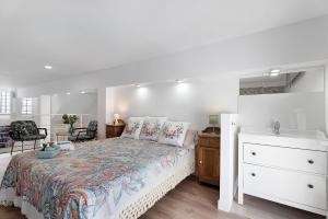 a white bedroom with a bed and a sink at Vista Alegre 22 B in El Paso