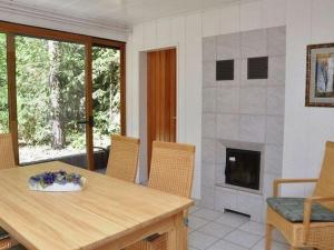 a dining room with a table and a fireplace at Waldhaus Jakober in Maasdorf