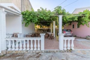 a patio of a house with a white fence at Pleasure Corfù Fish in Agios Georgios
