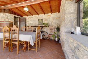 a dining room with a table and wooden chairs at Casa da Lage in Castelo do Neiva