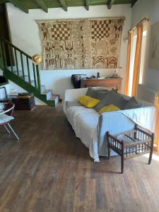 a living room with a bed with yellow pillows at Buvolaccia in Sampolo