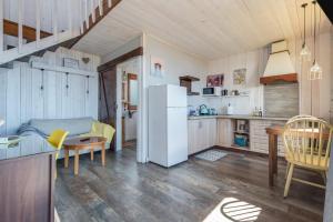a kitchen and living room with a white refrigerator at Las Hermanas A in Guía de Isora