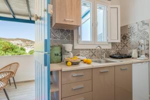 a kitchen with a sink and a counter top at Porto Galini Kalloni in Agios Ioannis