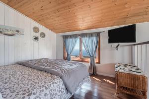 a bedroom with a bed and a flat screen tv at Las Hermanas A in Guía de Isora +22 photos