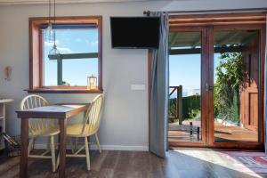 a dining room with a table and a flat screen tv at Las Hermanas A in Guía de Isora