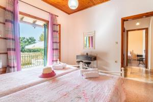 a bedroom with a large bed and a window at Princess House in Sidari