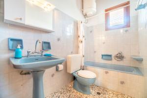 a bathroom with a sink and a toilet at Princess House in Sidari