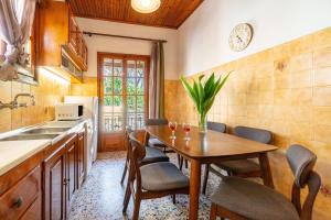 a kitchen with a table and chairs and a sink at Princess House in Sidari