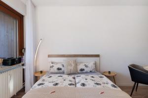 a small bedroom with a bed and two tables at Fw Moonlight mit Sauna, Schwimmbad in Schönwald +19 photos