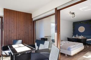 a bedroom with a bed and a table and chairs at Fw Moonlight mit Sauna, Schwimmbad in Schönwald
