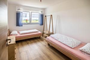 a room with two beds and a window at Ferienwohnung Häfele 1 in Bad Wurzach