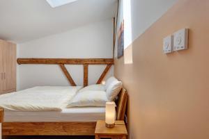 a small bedroom with a bed and a small table at Ferienwohnung Junge 3 in Lohe-Rickelshof