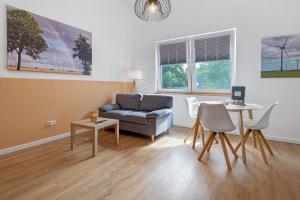 a living room with a couch and a table at Ferienwohnung Junge 3 in Lohe-Rickelshof