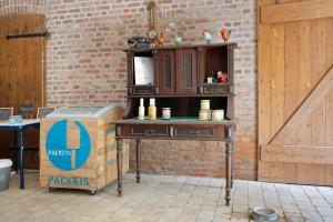 a wooden table next to a brick wall with a box at Ferienwohnung Junge 3 in Lohe-Rickelshof +27 photos