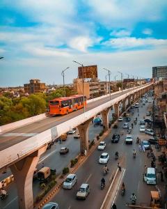 a busy highway with cars and a bus on a bridge at Hotel Royal One in Multan