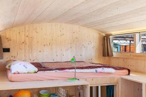 a wooden cabin with a bed in the middle at Loft Süd in Unterammergau