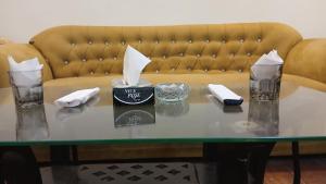 a coffee table with a couch in the background at Hotel Royal One in Multan