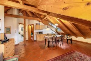 a kitchen and dining room with a table and chairs at Weingut Lieselehof Apt Panorama in Caldaro +7 photos
