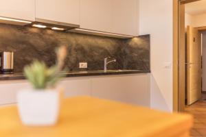 a kitchen with a sink and a table at Rosalpina Apt 2 in San Vigilio Di Marebbe +23 photos