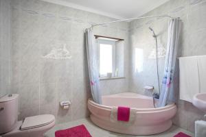 a bathroom with a tub and a toilet and a sink at Casa Imaginário Com Serenidade in Caldas da Rainha +17 photos