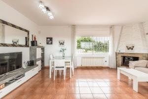 a living room with a couch and a table at Can Fogars in Fogás de Tordera