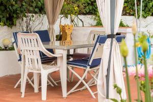 a table and four chairs and a table and a table at Can Fogars in Fogás de Tordera