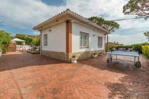 a house with a ping pong table in front of it at Can Fogars in Fogás de Tordera