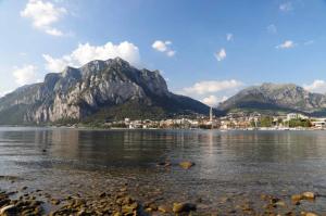 a body of water with mountains in the background at Mandello amorevole dimora in Lecco in Lecco
