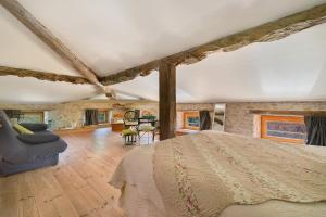 a bedroom with a bed and a living room at Chambres D'hôtes - Le Marlas in Rieucros +60 photos