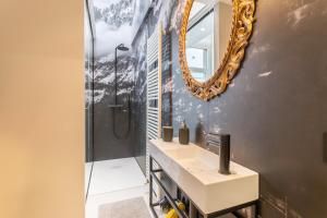 a bathroom with a sink and a mirror at Mandello amorevole dimora in Lecco in Lecco