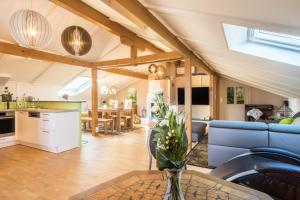 a living room with a couch and a table at Luxuriöses Penthouse-appartement in Höchst