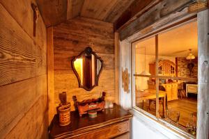a room with a mirror and a wooden wall at Schwarzwaldbauernhaus Wutach in Lembach +19 photos