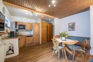 a kitchen and dining room with a table and chairs at Ferienwohnung Förchensee in Ruhpolding